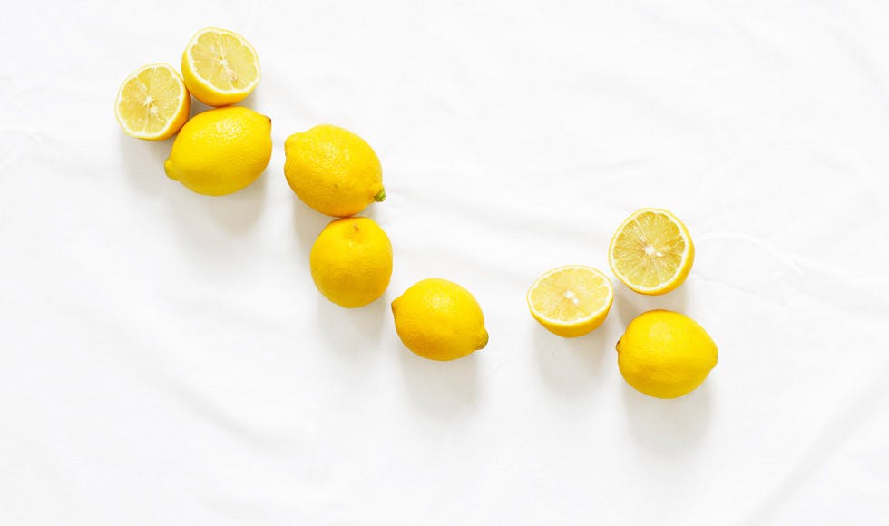 lemons scattered on a white bench