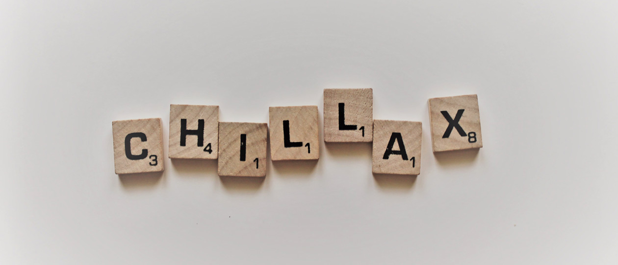 Scrabble letters spelling 'Chillax' on a white background