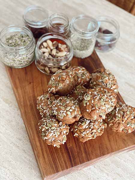 Apple banana  and nut wholesome muffins on a board with ingredients