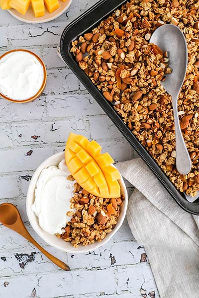 Baked granola with fresh mango and almonds