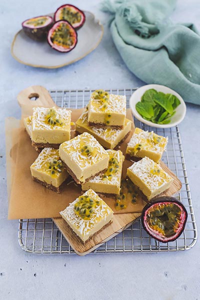 Pine and mango plant-based bars served on a chopping board with fresh passionfruit