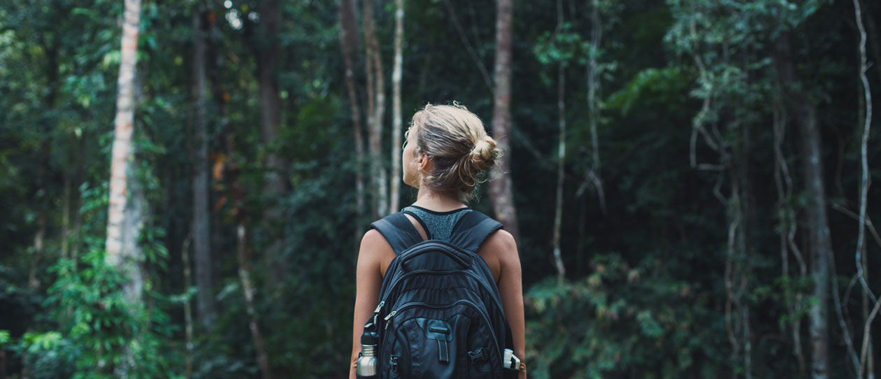 Young woman out for a hike in the bush with a backpack