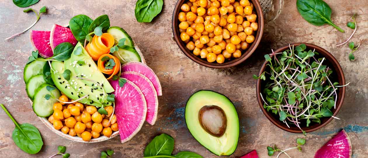 Vegan, detox Buddha bowl recipe with avocado, carrots, spinach, chickpeas and radishes