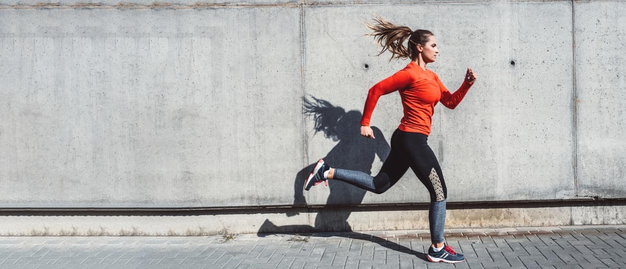 Woman in jogging outfit running outdoors