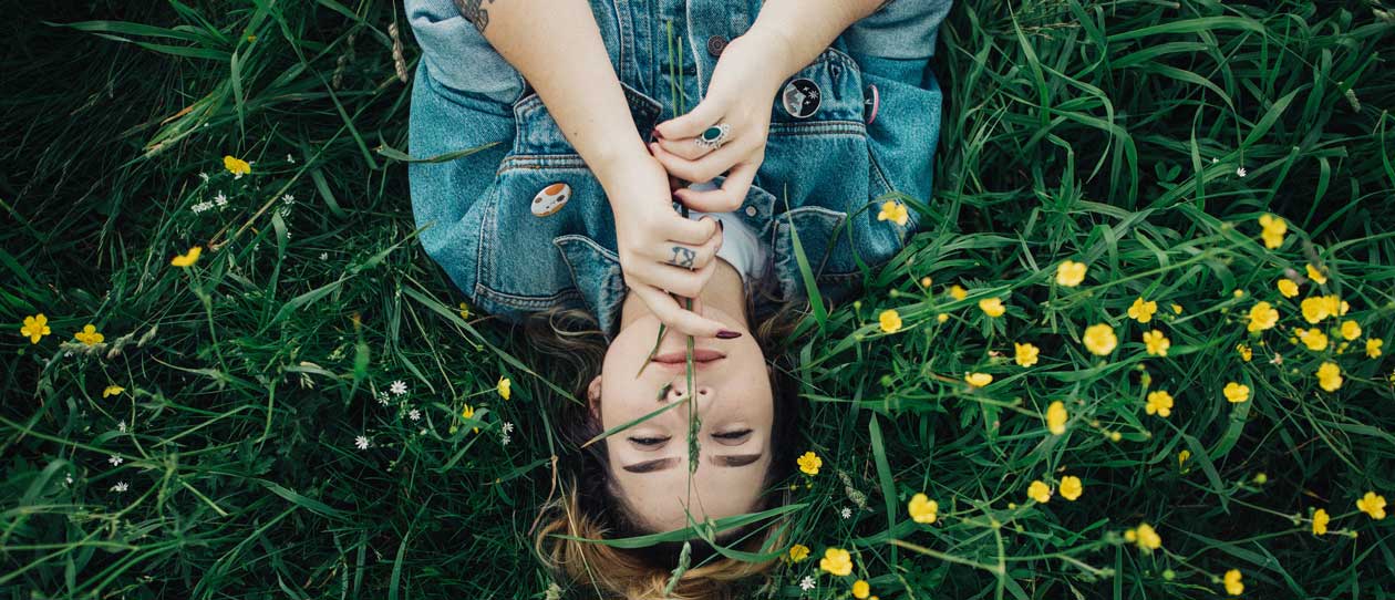 Woman lying on her back in a meadow