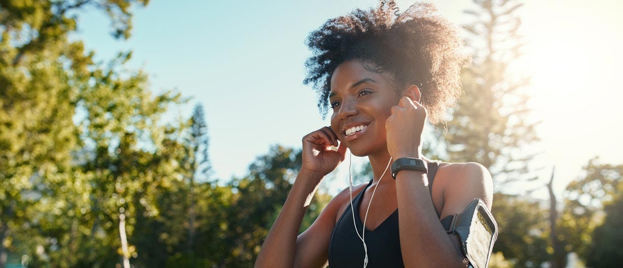 Young woman jogging while listening to music