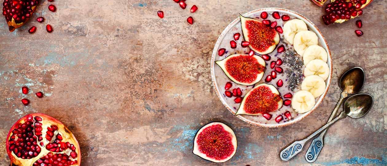 Fresh figs, banana and pomegranate smoothie bowl 