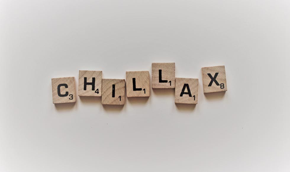 Scrabble letters spelling 'Chillax' on a white background
