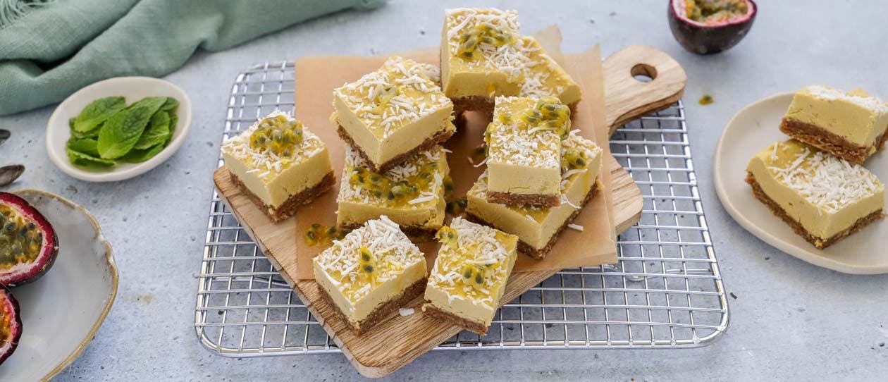 Pine and mango plant-based bars served on a chopping board with fresh passionfruit