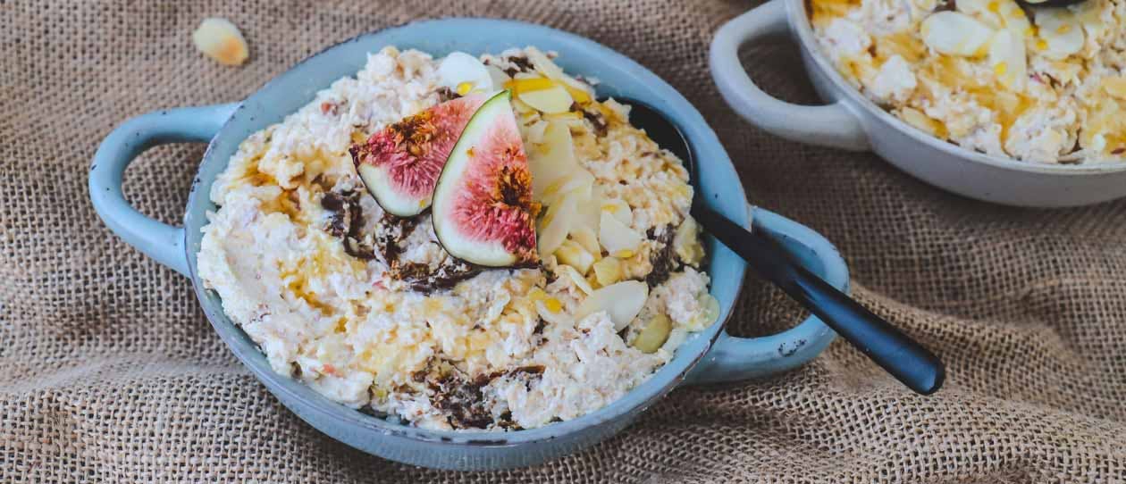 Muesli with figs and honey in a blue bowl