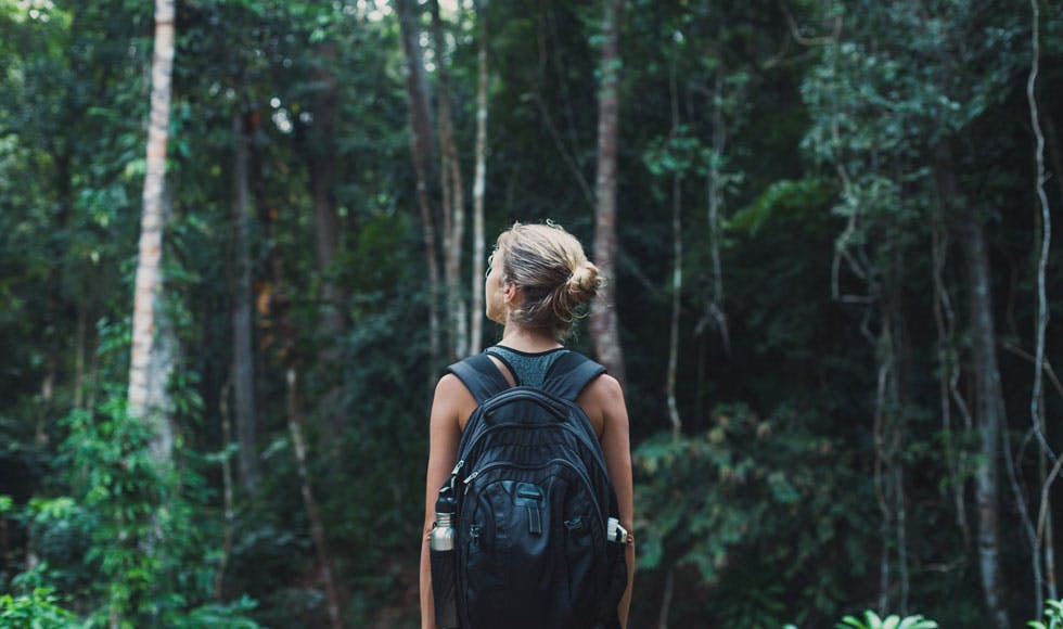 Young woman out for a hike in the bush with a backpack
